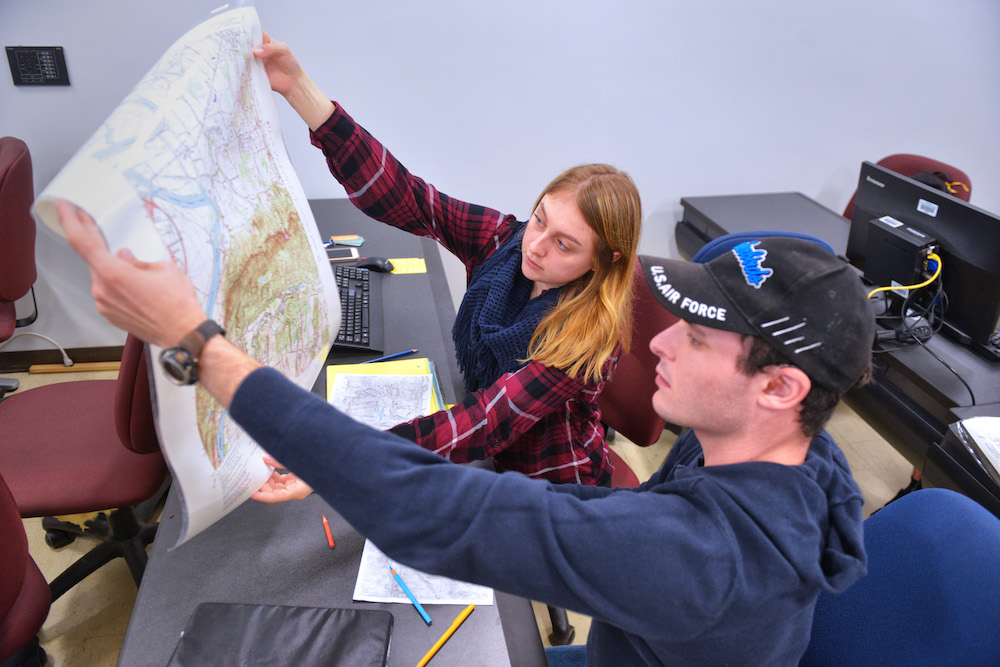 Two students examine a map